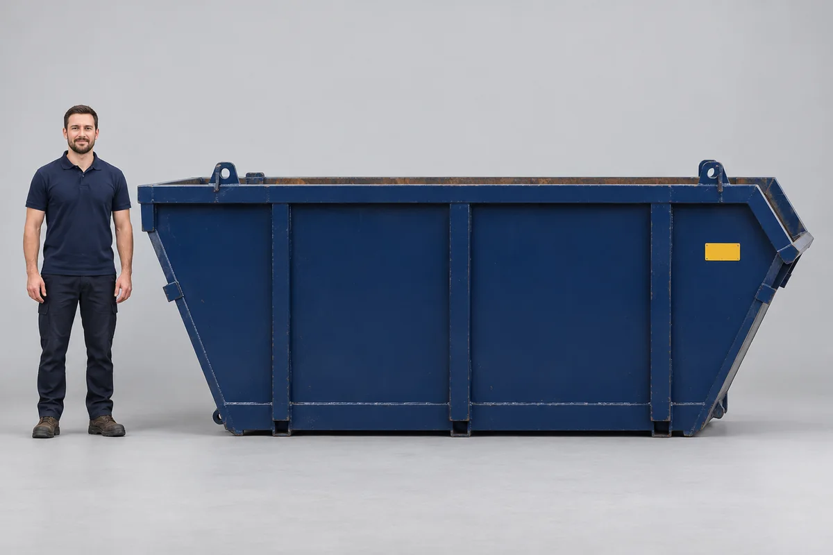 Man standing beside a 10-yard blue skip