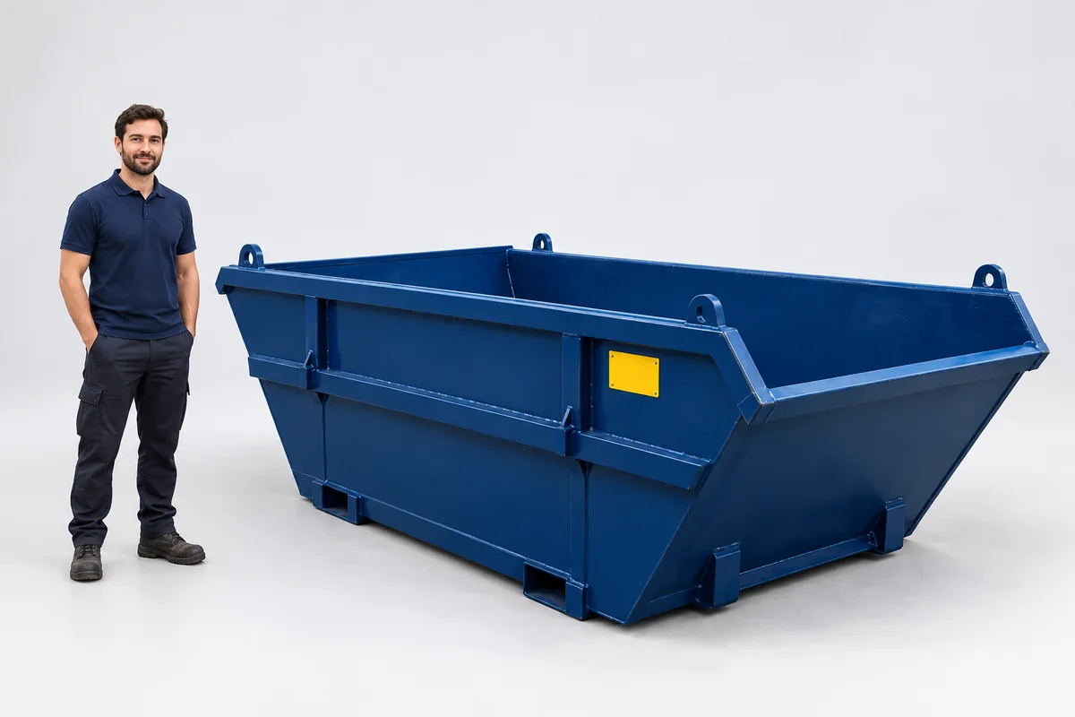 Man standing beside a 8-yard blue skip